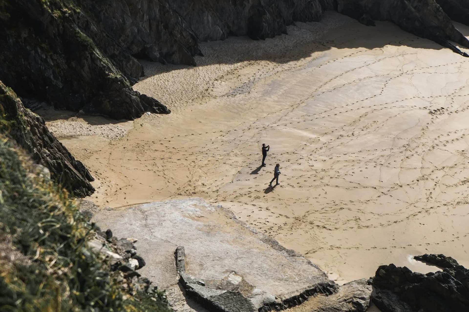 two people walking on beach